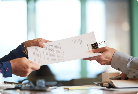 Person handing over a document for certified translation